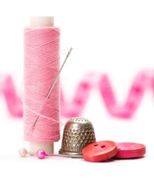 Sewing accessories: thread, needle and thimble Stock Photos