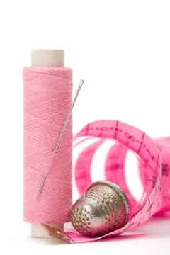Sewing accessories: thread, needle and thimble Stock Photos