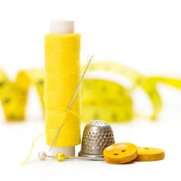 Sewing accessories: thread, needle and thimble Stock Photos