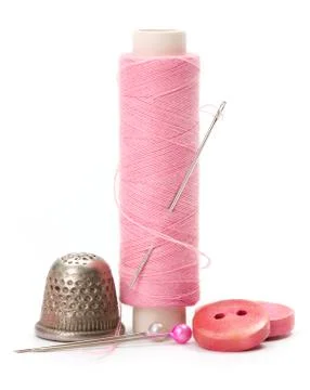 Sewing accessories: thread, needle and thimble Stock Photos