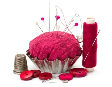 Sewing accessories: thread, needle, thimble and pincushion Stock Photos