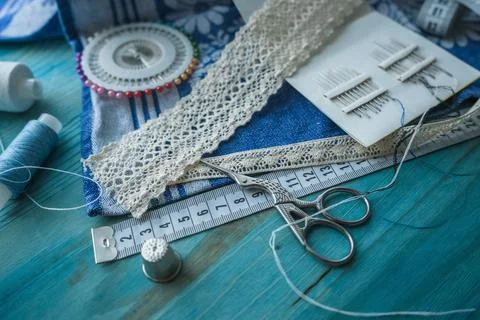 Sewing accessories with threads needls fabric lace scissors and measuring tap Stock Photos