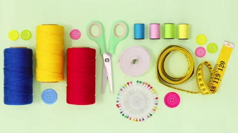 Sewing and knitting threads and other items ordering on green theme. Stop motion Stock Footage 154971665