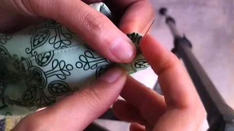 Sewing a button on shirt Video stock 246113531