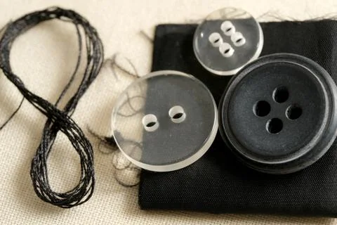 Sewing buttons and thread creates fashion magic at home Foto stock