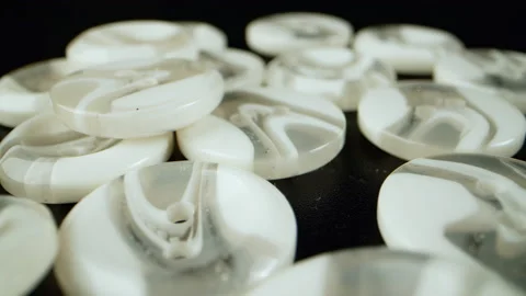 Sewing buttons. close-up. White sewing buttons slide macro shot. Concept of Stock Footage 194420541