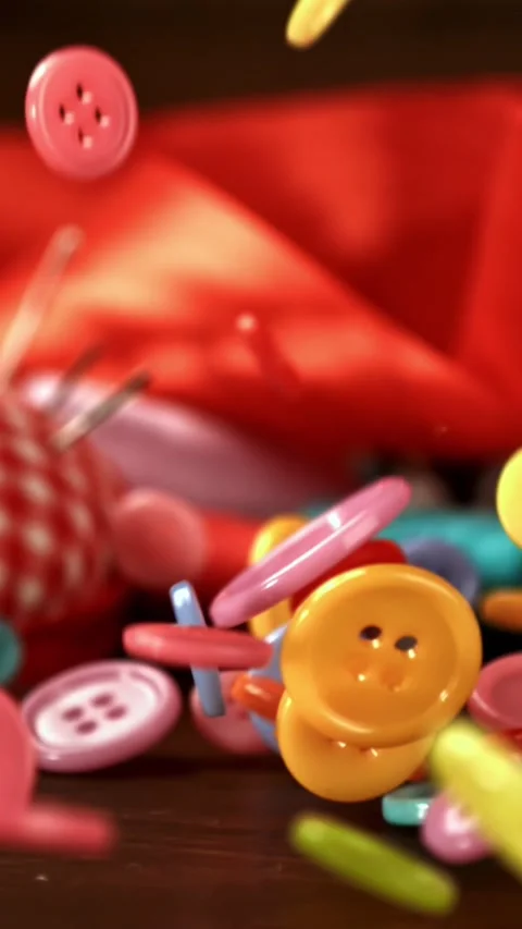 Sewing buttons fall on a wooden table. Filmed on a high-speed camera at 1000 fps Stock Footage 335366210