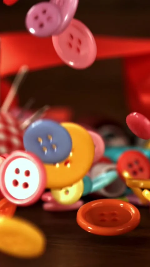 Sewing buttons fall on a wooden table. Filmed on a high-speed camera at 1000 fps Stock Footage 335368520