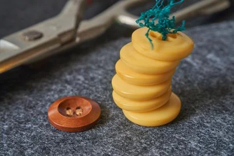 Sewing buttons, thread, scissors on needle punched nonwoven fabr Stock Photos