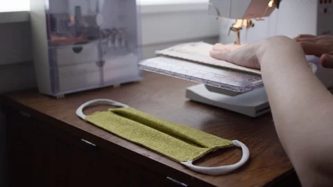 Sewing cloth masks to control spread of covid-19 Stock Footage 128160236