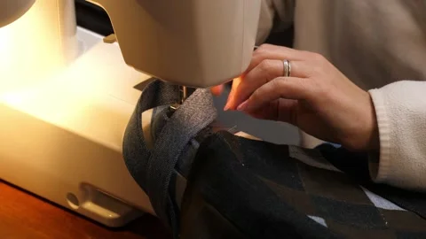 Sewing Cloth thread sewing machine scissors cutting creating Stock Footage 320033842