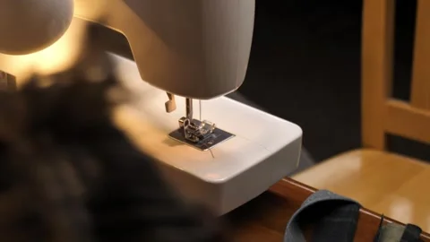 Sewing Cloth thread sewing machine scissors cutting creating Stock Footage 320042859