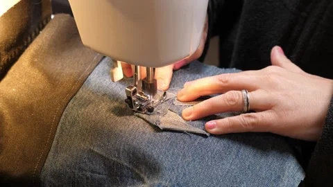 Sewing Cloth thread sewing machine scissors cutting creating Stock Footage 320045639