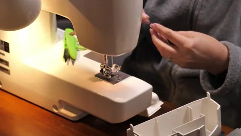 Sewing Cloth thread sewing machine scissors cutting creating Stock Footage 320046765