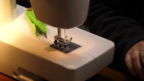 Sewing Cloth thread sewing machine scissors cutting creating Stock Footage 320047612