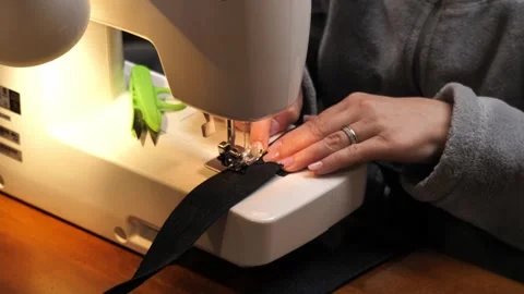 Sewing Cloth thread sewing machine scissors cutting creating Stock Footage 320050978