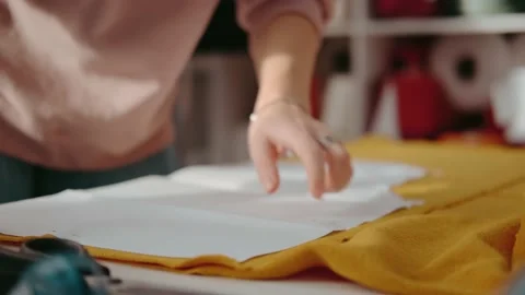 Sewing clothes: pattern on fabric. Close up, without face Stock Footage 143690738