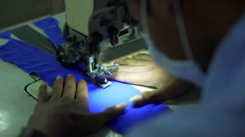 Sewing clothes on a sewing machine in garment factory Video stock 210164690