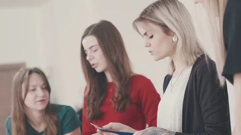 Sewing course students look at the fabric. The choice of fabric Stock-Footage 74243802