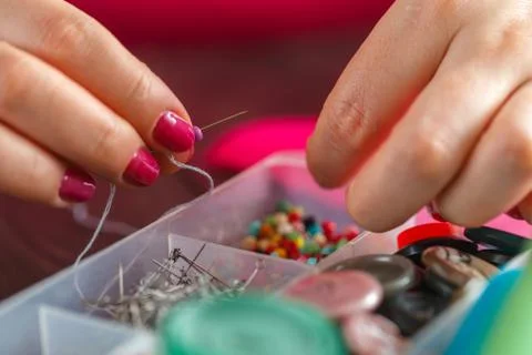 Sewing craft needle textile thread in human finger Stock Photos