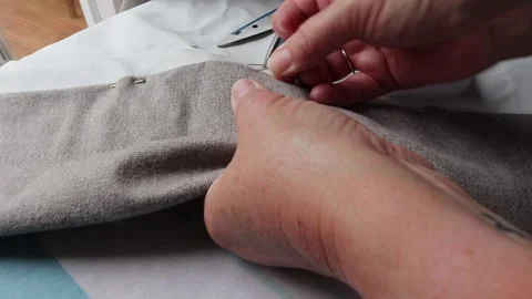 Sewing curtains turning up hem using pins and thread Video stock 139051154