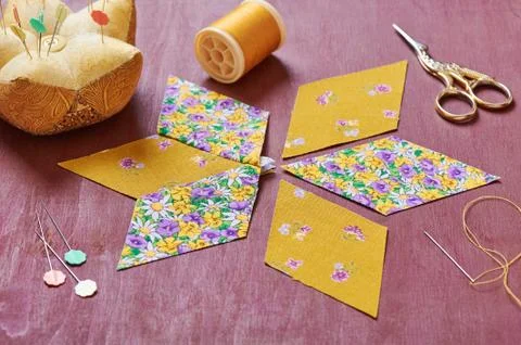 Sewing of  element quilt in progress, prepared cut pieces around accessories Stock Photos