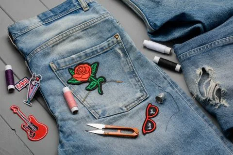 Sewing embroidered patch to denim 写真素材