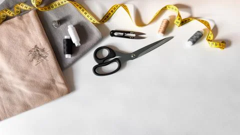 Sewing essentials flat lay with fabric, scissors, and measuring tape Stock-Fotos