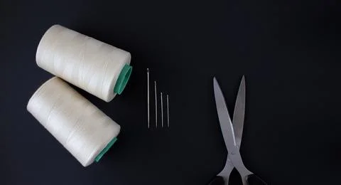 Sewing gold threads, needles, scissors. A top view, flatlay.Sewing flatlay on a Stock Photos
