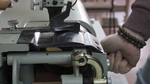 Sewing grinder in a manufacturing sewing workshop or textile sewing factory, Stock Footage 125893482