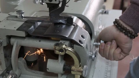 Sewing grinder in a manufacturing sewing workshop or textile sewing factory, Stock Footage 125893512
