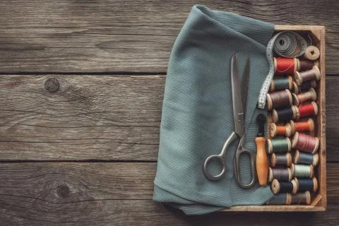 Sewing items: retro tailoring scissors, measuring tape, spools of threads Stock Photos