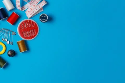 Sewing items: tailoring scissors, measuring tape, spools of multicolored thre Stock Photos