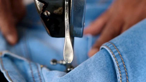 Sewing jeans with sewing machine. Tailor working Stock Footage 120495702