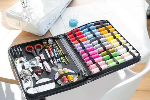 Sewing layout with multicolored spools of thread close-up, needles, electri.. Foto stock