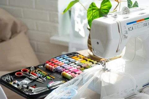 Sewing layout with multicolored spools of thread close-up, needles, electri.. Foto stock
