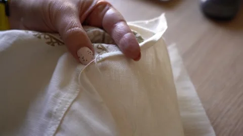 Sewing lessons on how to make precise stitches on fabric with hand tools Stock Footage 329559812