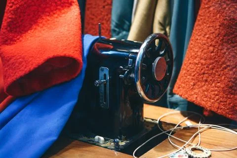 Sewing machine among clothes. Stock Photos