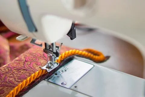 Sewing machine and decorative edging cord Stock Photos