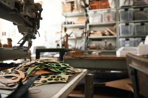 Sewing machine and material on a leather studio table Stock Photos