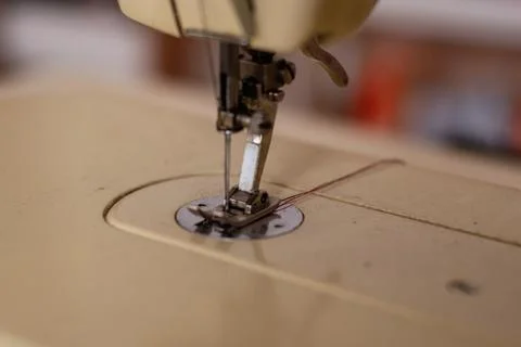 Sewing machine and threaded needle close up Stock Photos