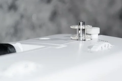 Sewing machine. Bobbin on a sewing machine. Close-up. Stock Photos