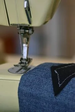 Sewing machine close up with jeans. Hobbies and leisure. Stock Photos