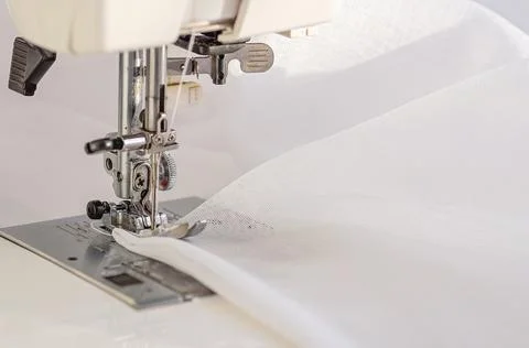 Sewing Machine Close-Up with White Fabric 스톡 사진