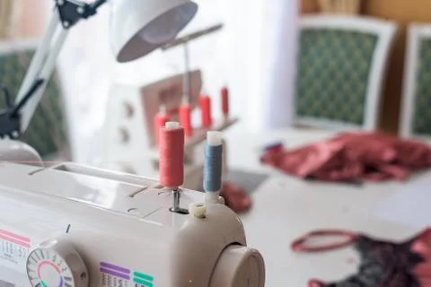 Sewing machine with coils of coral thread . close-up threads. Stock Photos