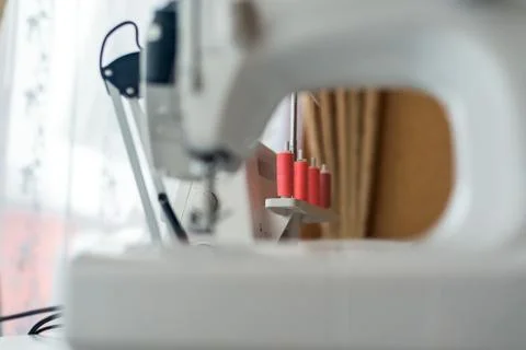 Sewing machine with coils of coral thread . close-up threads. Stock Photos
