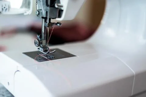 Sewing machine with coils of thread close-up paws. Stock Photos