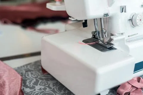 Sewing machine with coils of thread close-up paws. Stock Photos