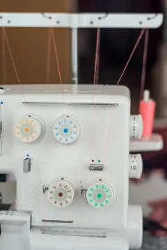 Sewing machine with coils of thread close-up paws. Stock Photos