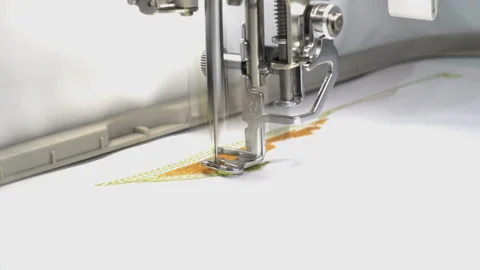 Sewing machine embroider a pattern on the fabric close-up. HD video Stock Footage 88565882